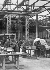 Concentration camp prisoners at a Messerschmitt AG aircraft factory, probably 1943 Concentration camp prisoners at Messerschmitt factory.png