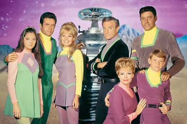 1967 publicity photo showing cast members Angela Cartwright, Mark Goddard, Marta Kristen, Bob May (Robot), Jonathan Harris, June Lockhart, Guy William