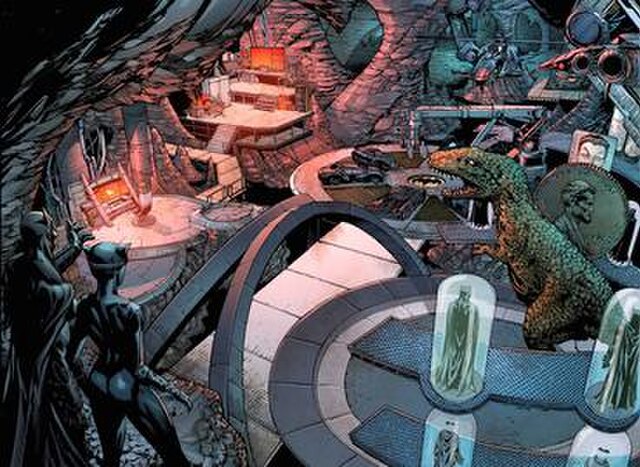 The Batcave in Forever Evil #4 (Feb. 2014). The animatronic Tyrannosaurus Rex, giant Lincoln penny, and oversized Joker playing card are seen on the r