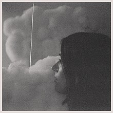 A charcoal drawing of a woman's face looking at clouds