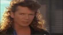 Iva Davies in the music video for "Electric Blue", which was co-written by Davies and John Oates IcehouseVideo-ElectricBlue-IvaDavies-1987.png