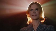 Kidman seated and lit from behind by colorful lights emanating from a movie projector. A raised platform was constructed inside the theater to achieve this effect. AMC Kidman lights.jpg