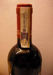 A paper strip denoting DOCG on a bottle of 2012 Barbera d'Asti DOCG label.jpg