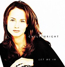 A bust shot of a woman in a black shirt, leaning toward the image's left, on a white background. The text "Chely Wright" and "Let Me In" are superimposed over her left shoulder.