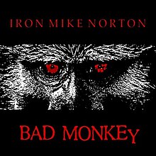 Black square with a picture of the eyes of a baboon with the words, Iron Mike Norton and Bad Monkey