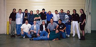 The sixteen finalists at the first B5 CCG World Championships in Pomona, California. Pictured center holding the Vorlon action figure is Inaugural B5 CCG World Champion Serge Lavergne. First Ones.jpg