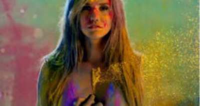 A still of the music video that shows Kesha "unzipping" herself, transforming into stardust. The scene is intended to be symbolic with the transformat