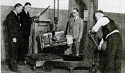 Plymocoupe engine in US Government laboratories tested by experts of the Bureau of Air Commerce. The silver housing mounted to the right of the engine block is the gear reduction unit. Plymocoupe engine tests.jpg