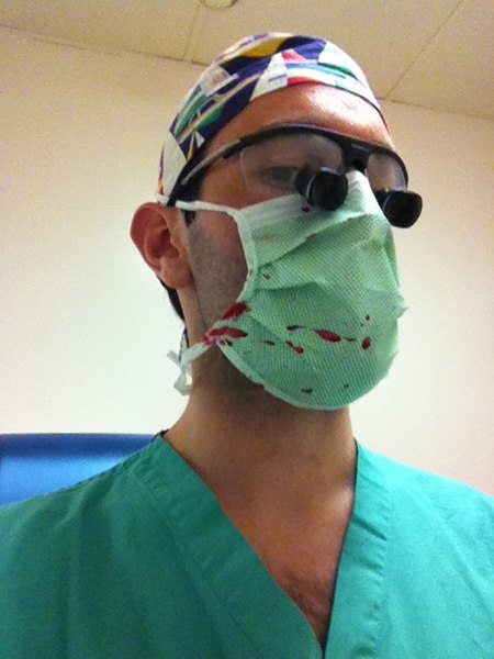 File:Surgeon wearing loupes with blood spatter.jpg