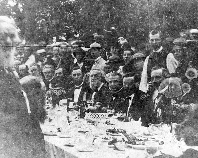 Photograph of U.S. President Andrew Johnson at a banquet in his honor during the Swing Around the Circle speaking tour. Johnson appears seated in the 