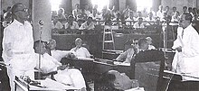 The post-World War II Philippine Senate in 1951: Cipriano P. Primicias, Sr., far left, debates Quintin Paredes, far right. In the middle are Justiniano Montano, Mariano Jesus Cuenco, Enrique B. Magalona, and Francisco Delgado; in the foreground is Edmundo Cea. Deliberations were once held at the Old Legislative Building. Sen. Primcias debates Sen. Paredes.jpg