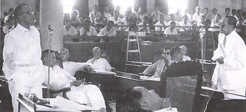 The old Philippine Senate, 1951: Senator Primicias at extreme left, debates Senator Quintín Paredes at extreme right. In the middle are Senators Justi
