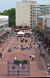 The Civic Centre in Wythenshawe. The Park Court multi-storey flats at the far end were demolished in 2007, replaced by new retail and office buildings.