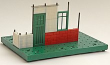 Basic construction elements: base, rods and bricks, from a Plimpton era Bayko set BuildingWithBayko.jpeg