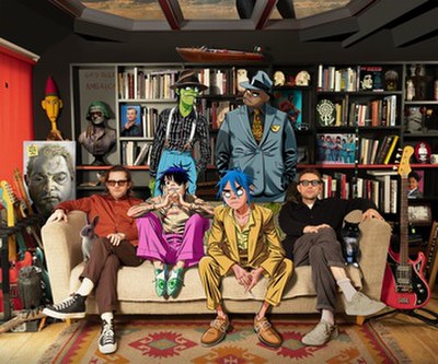 Gorillaz in 2020. Jamie Hewlett (left) and Damon Albarn (right) with animated members Murdoc Niccals, Russel Hobbs, 2-D, and Noodle.