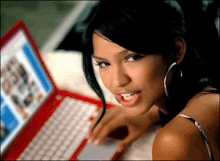 Cassie lying on a bed beside a red laptop in the social networking-themed music video for "Long Way 2 Go". CassieLongWay2Go.gif