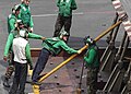 Green shirts are generally aircraft or equipment maintenance personnel.