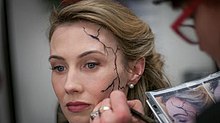 Makeup artist Robin Beauchesne applying special prosthetics to Wynn Everett to depict Whitney Frost's Zero Matter "crack" Wynn Everett make-up effects in Agent Carter.jpg