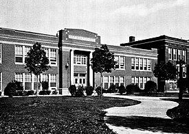 Plymouth's 1925 high school building was designed by architect Louis Hancock. The third high school, seen at the far right, became the junior high school. Plymouth High School 1932.jpg