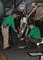 Squadron aircraft mechanics wear green shirts.