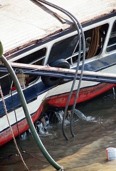 The port side of Marchioness, showing the point of the second impact from Bowbelle. The wooden planking on top was the floor of the upper saloon, whic