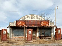 A now-abandoned gas station and general store in Cogar, Oklahoma, was used in a scene from the film. The Colvert sign has since been removed, revealing the full name of the business. Cogar Kelly.jpg