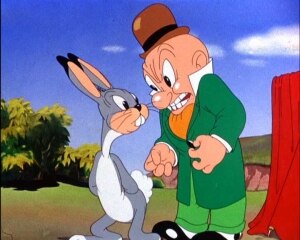 Elmer Fudd, resembling his prototype early in his career, is annoyed by a rabbit in Elmer's Candid Camera.