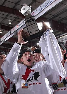 Canada West's Justin Gvora with the first ever awarded WJAC Championship Trophy and Medallion (2006) WJAC Canada West with Trophy.jpg