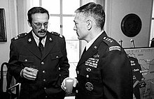 Generals Clark and Ćosić talking at a meeting