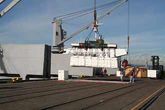 Pulp is loaded into the hold of a ship using ship's crane Portoflongview pulp.JPG