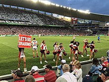 The Flames, the cheersquad for the St. George Illawarra Dragons, performing during an NRL match in 2018. Dragons cheerleaders.jpg