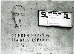 Francoist propaganda graffiti in Catalonia: "If you are Spanish, speak Spanish." Francoist propaganda graffiti, "If you are Spanish, speak Spanish".png