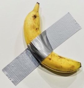 A yellow banana with a strip of silver-colored tape across, attached to a white wall