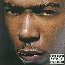 The cover has the artist giving a mean and threatening look behind a black background. On the bottom right corner of the cover is the Parental Advisory label.