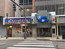 The northernmost entrance to the Park and Shop Ramp's Arcade Shops, including their Candyland store and a segment of their parking ramp.