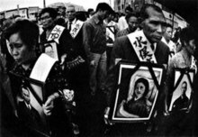 Minamata patients and family members hold photographs of their dead during a demonstration (W. E. Smith) Patients and family members hold photographs of their dead.jpg