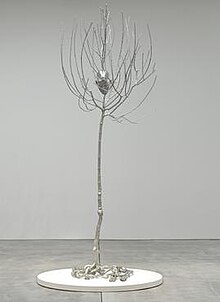 Head in Tree is an example of Pondick's hybrid sculptures; here, the artist has incorporated her life-sized head into the center of a tree, cast in matte finish stainless steel, highly polished for the back of the head. Head in Tree, 2006-2008.jpg