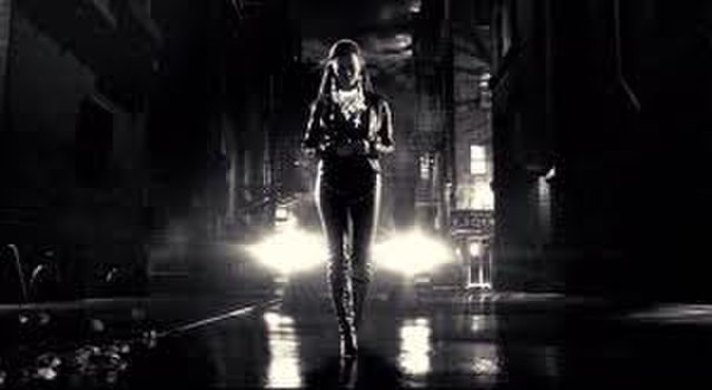 Becky (Alexis Bledel) walking down a street, an example of the film's neo-noir atmosphere