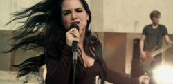 JoJo as she is performing with her band in the music video for "Disaster" Disaster (5).png