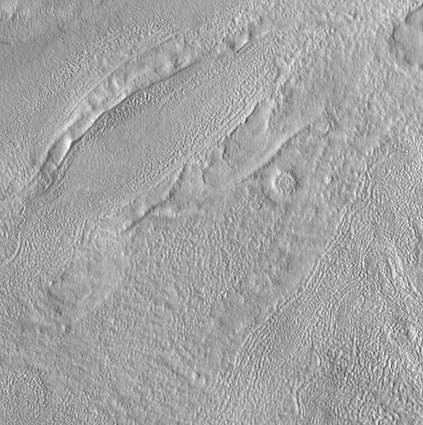 Kufra Crater Floor, as seen by HiRISE. Pits are thought to be caused by escaping water.
