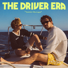 The cover depicts the band members sitting sideways on a boat, in a clear sky background, with the album logo in greenish yellow font on top