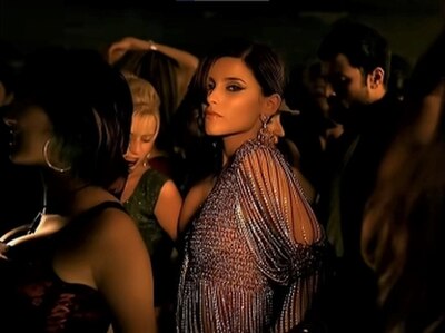 A scene where Furtado is shown surrounded by individuals at a club in the music video.
