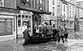 Monmouth flooding, 1963. Volunteers organise a boat service in Monnow Street.