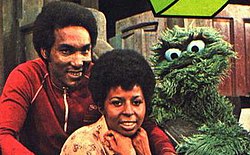 Miller as Gordon, with Long as Susan and Caroll Spinney as Oscar the Grouch. Undated publicity photo, likely from 1972. Sesame Street Hal Miller as Gordon with Susan and Oscar.jpg