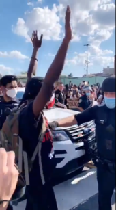 Still image from a viral video depicting a protester as a police officer moves to remove his mask and pepper spray him. NYPD removes protester's mask to pepper spray.png