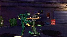 Kick-Ass kicks an enemy in the groin.