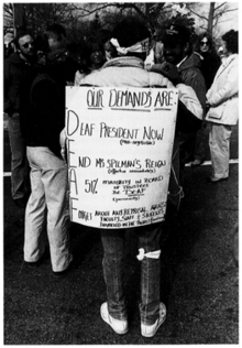 A protester displaying their demands Poster from Deaf President Now.png