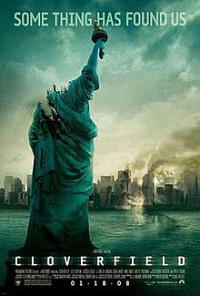The image portrays a decapitated Statue of Liberty in front of a partially wrecked city