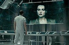 Helena Bonham Carter as Skynet, under the guise of the late Dr. Serena Kogan on a monitor, with Sam Worthington as Marcus Wright.