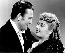With Joan Blondell in Lady for a Night (1942) John Wayne - Joan Blondell - 1942.jpg